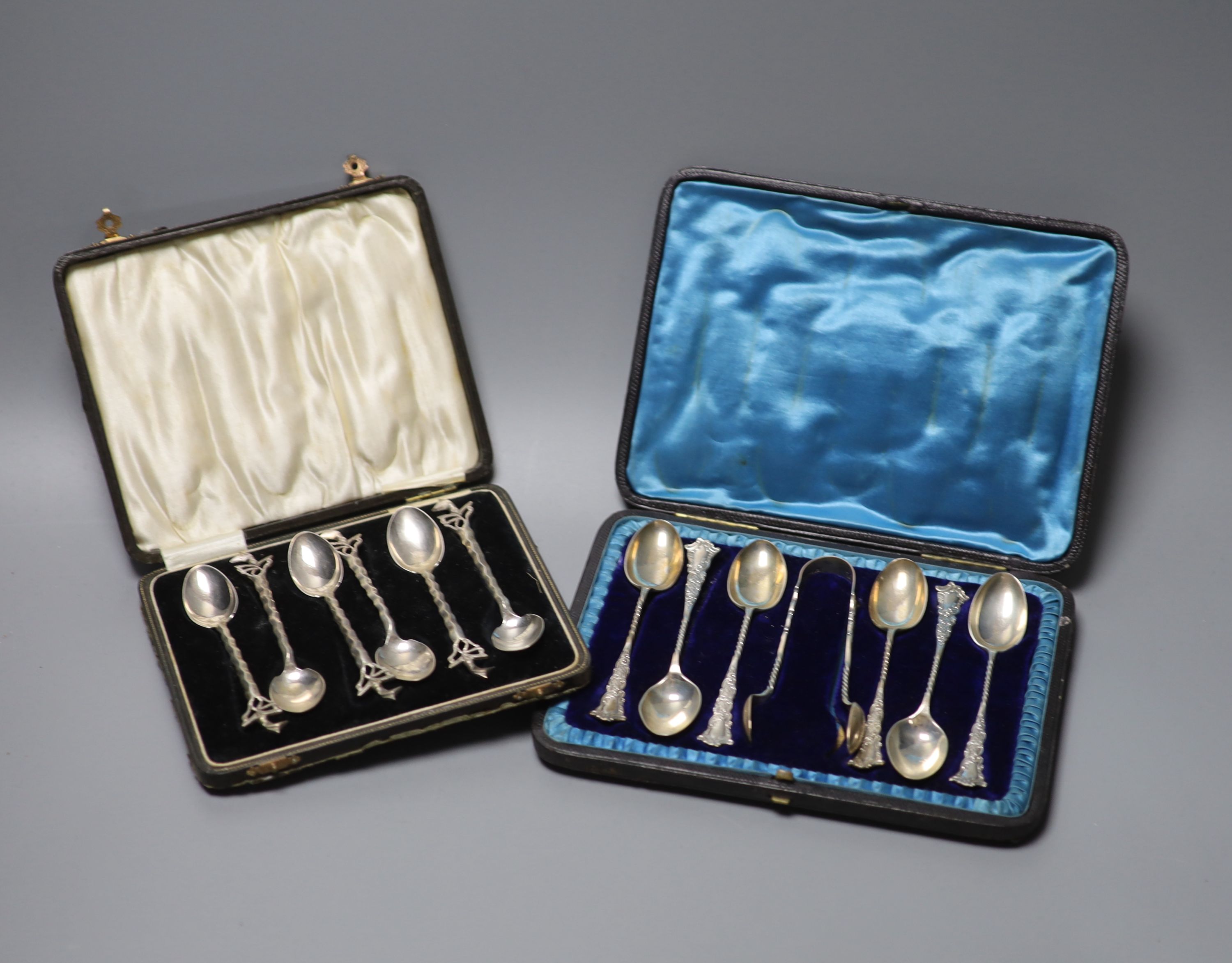 A Victorian cased set of six silver teaspoons with tongs, London, 1897 and a cased set of six white metal teaspoons.